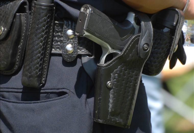 Police officers gun holster from behind